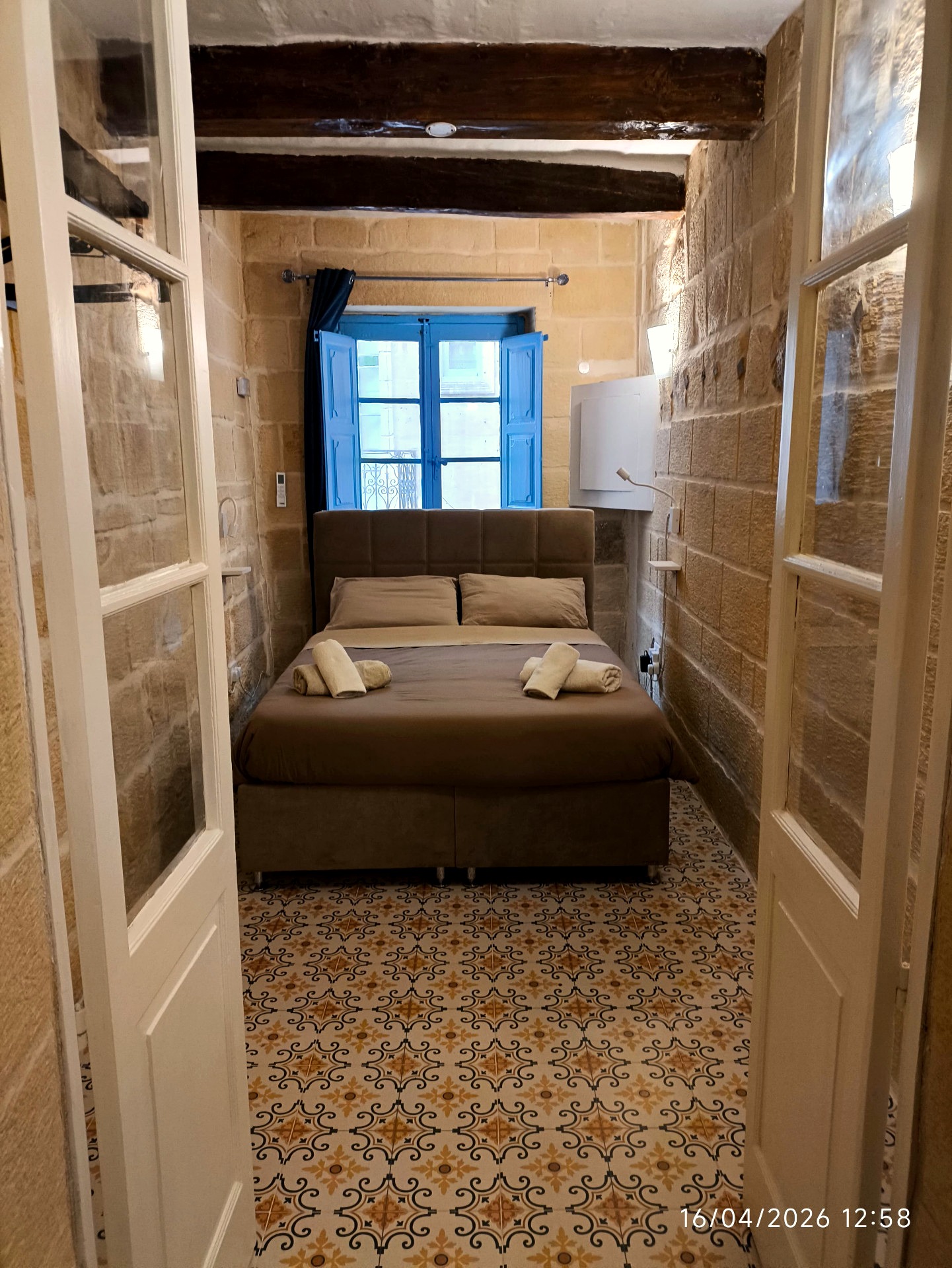 Traditional limestone bedroom with blue Maltese shutters