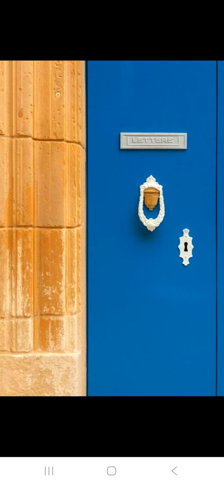 Traditional blue Maltese door with limestone surround